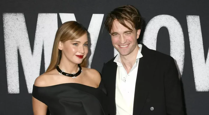 Jennifer Lawrence and Robert Pattinson pose for the cover of a glossy magazine.